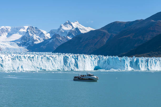 Blue-tinted glacier in Patagonia with reflective water